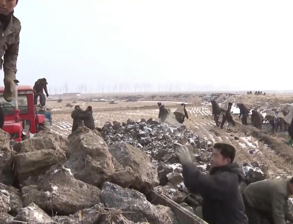 PHOTO: Korean Central Television shows workers handling manure, a common theme during the channel's broadcasts.