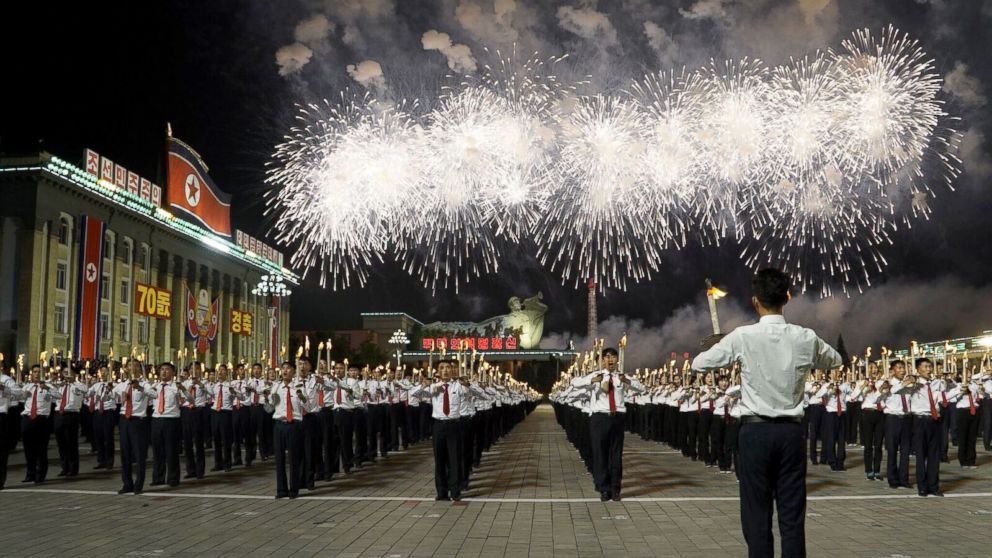 North Korean university and high school students participate in North Korea's 70th anniversary celebrations, known as the Torchlight Parade.