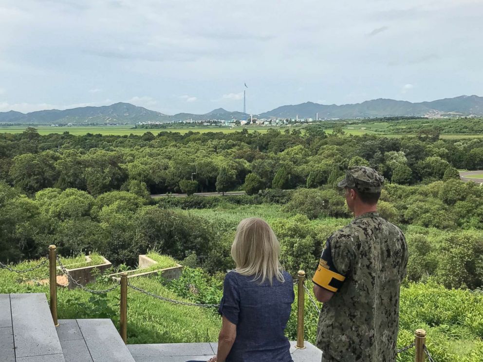 PHOTO: ABC Chief Global Affairs Correspondent Martha Raddatz and Lt. Commander Daniel McShane look over the border into North Korea, where an empty propaganda village blares music.