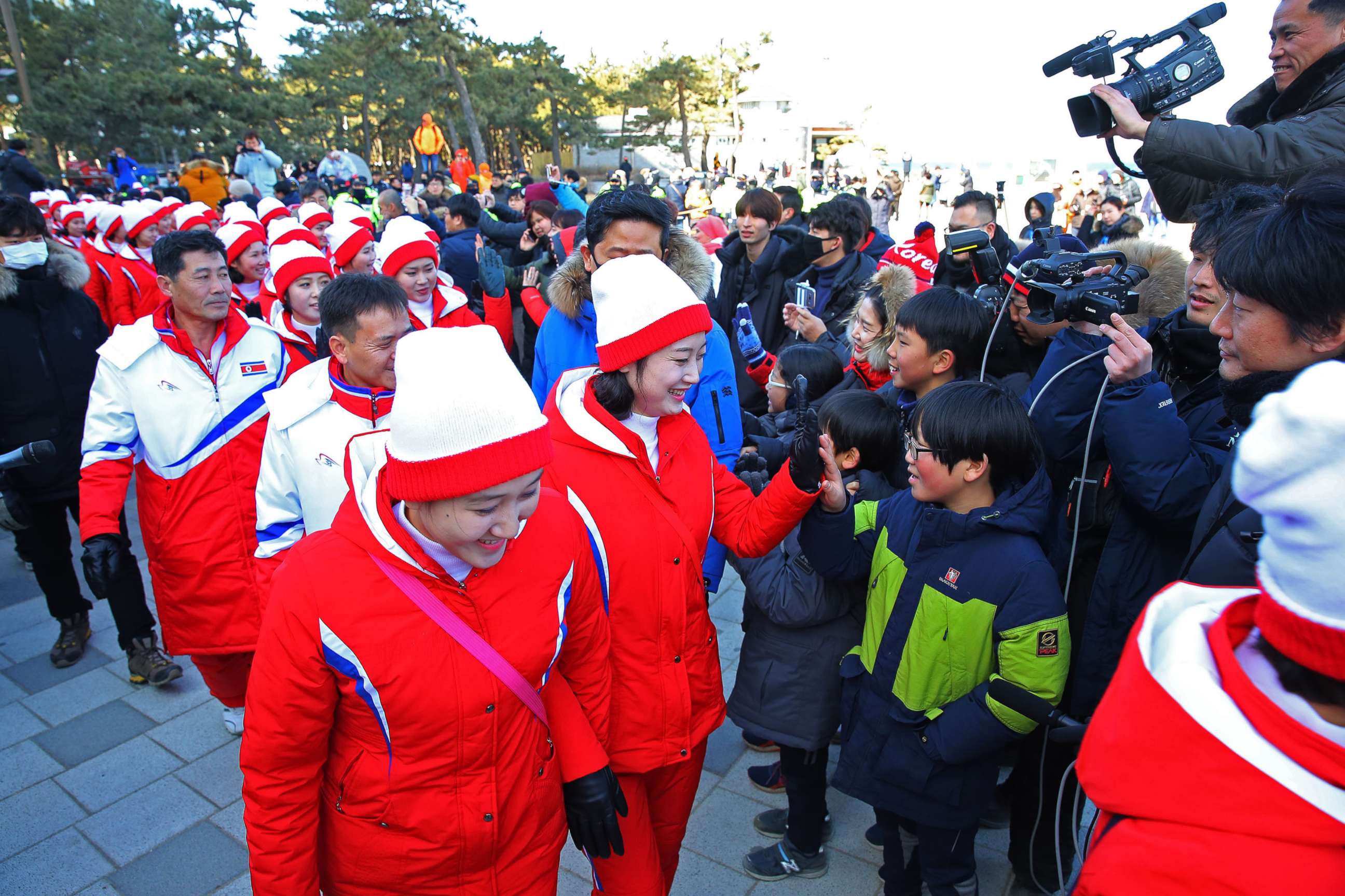 PHOTO: A group of North Korean cheerleaders for the Pyeongchang Winter Olympics greets South Koreans as they visit Gyeongpo Beach in Gangneung, South Korea,  Feb. 13, 2018. 