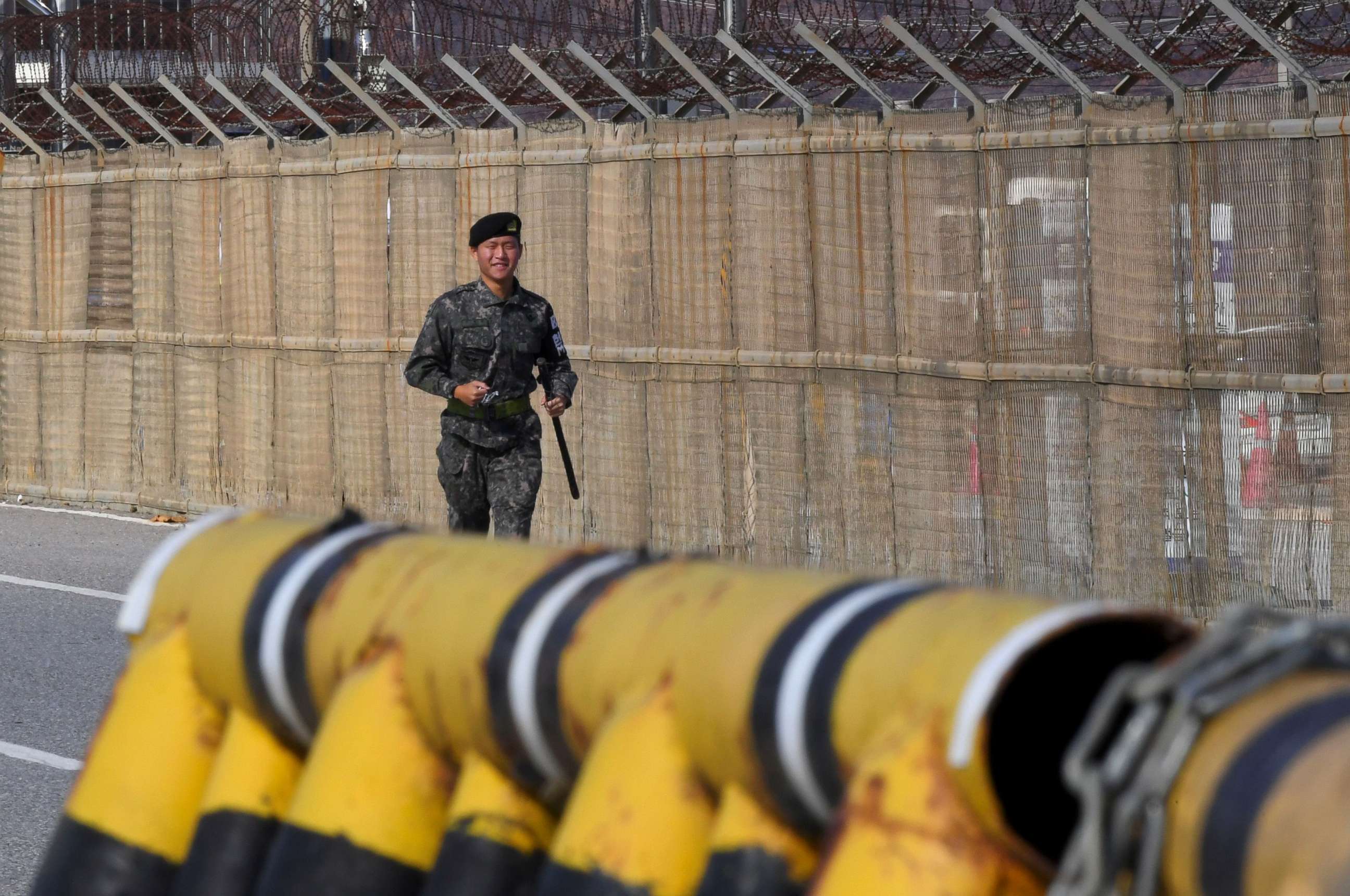 PHOTO: A South Korean soldier runs along a military fence on the road leading to the truce village of Panmunjom at a South Korean military checkpoint in the border city of Paju near the Demilitarized Zone (DMZ) dividing the two Koreas, Nov. 14, 2017.