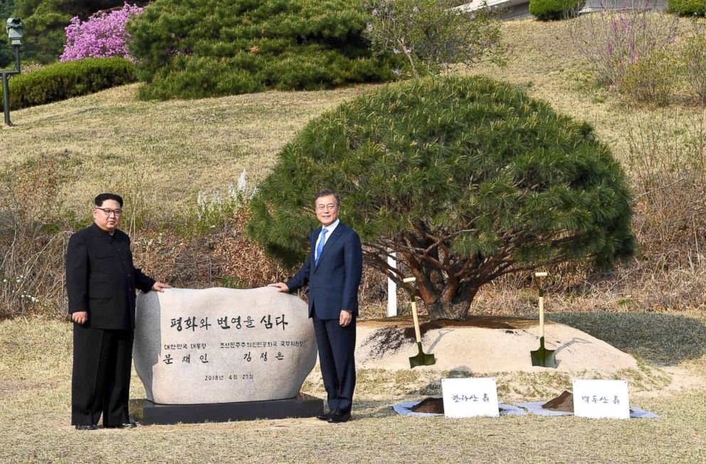 PHOTO: Kim Jong Un and Moon Jae-in participate in a tree-planting ceremony next to the Military Demarcation Line that forms the border between the two Koreas at the truce village of Panmunjom, April 27, 2018.