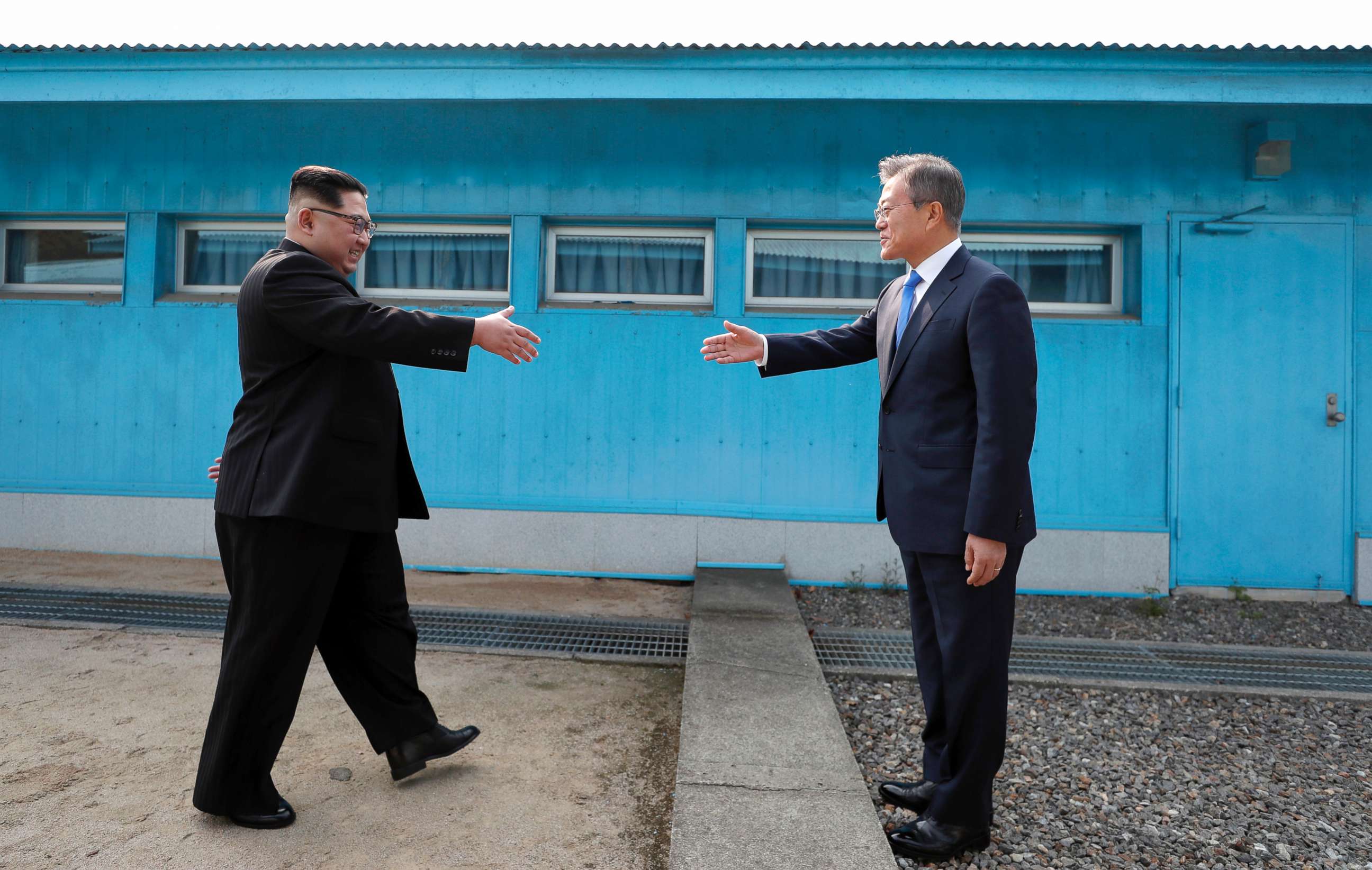 PHOTO: North Korean Leader Kim Jong Un, left, and South Korean President Moon Jae-in shake hands over the military demarcation line upon meeting for the Inter-Korean Summit, April 27, 2018, in Panmunjom, South Korea.
