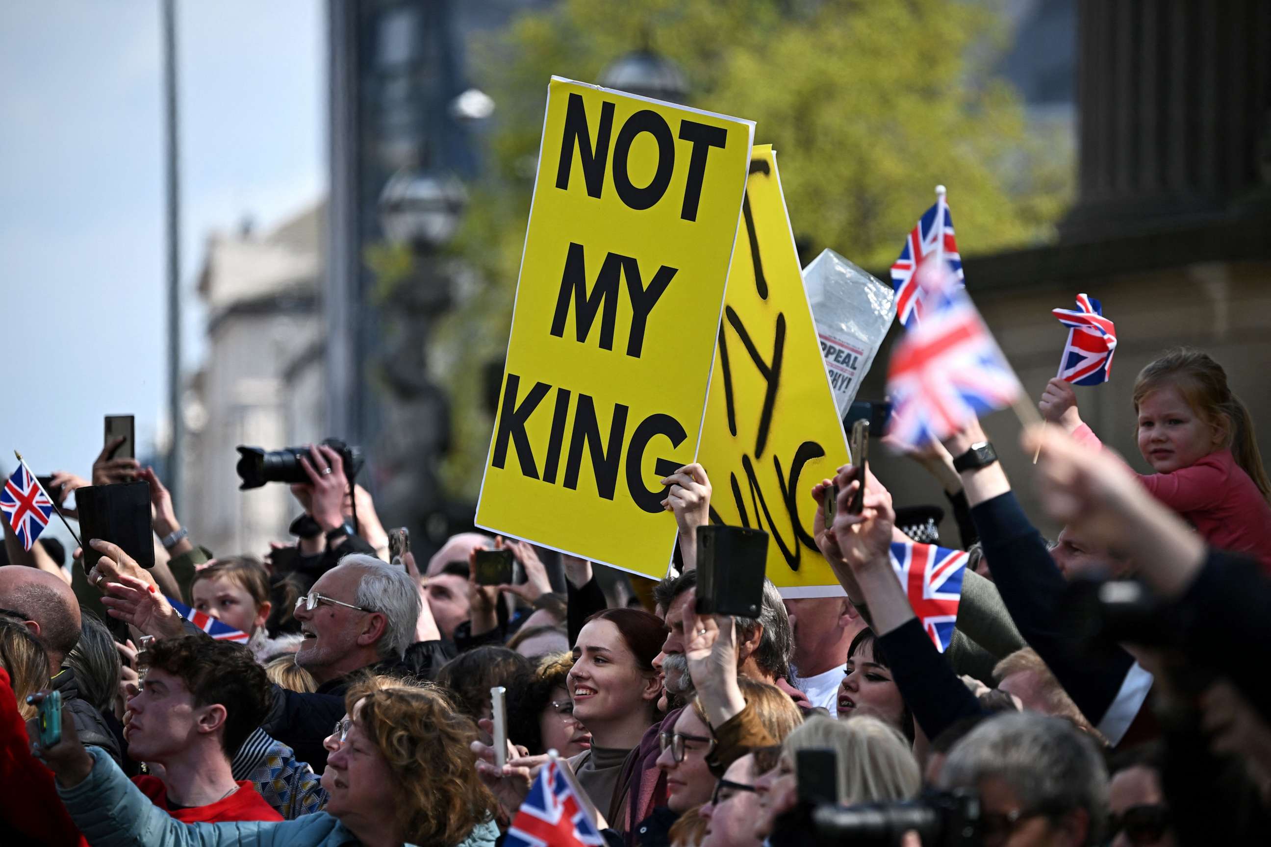 PHOTO: Protesters hold signs reading "Not My King" ahead of the arrival of Britain's King Charles III and Britain's Queen Consort Camilla for a visit to the Liverpool Central Library on April 26, 2023.