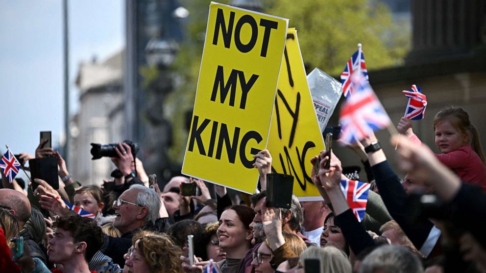 PHOTO: Protesters hold signs reading "Not My King" ahead of the arrival of Britain's King Charles III and Britain's Queen Consort Camilla for a visit to the Liverpool Central Library on April 26, 2023.