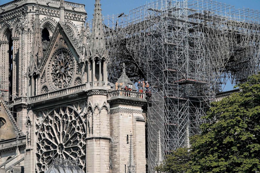 PHOTO: Firefighters and technicians work on a balcony of Notre-Dame de Paris Cathedral in Paris, April 19, 2019, four days after a fire devastated the cathedral.