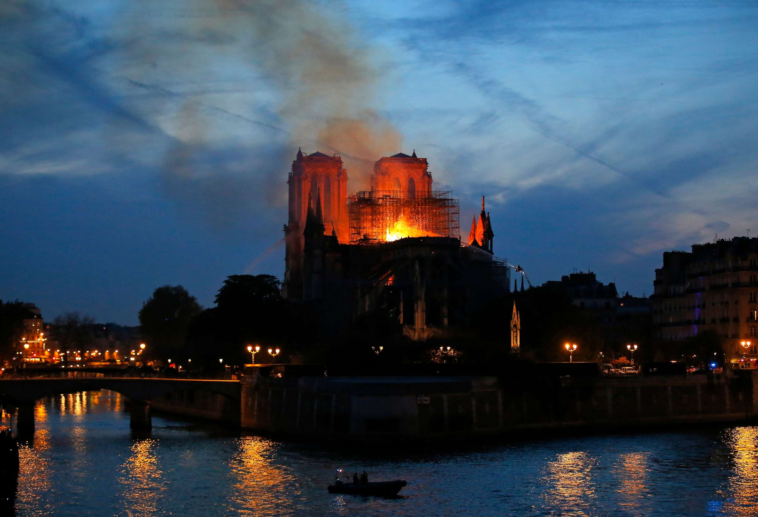 PHOTO: Firefighters tackle the blaze as flames rise from Notre Dame cathedral as it burns in Paris, April 15, 2019.