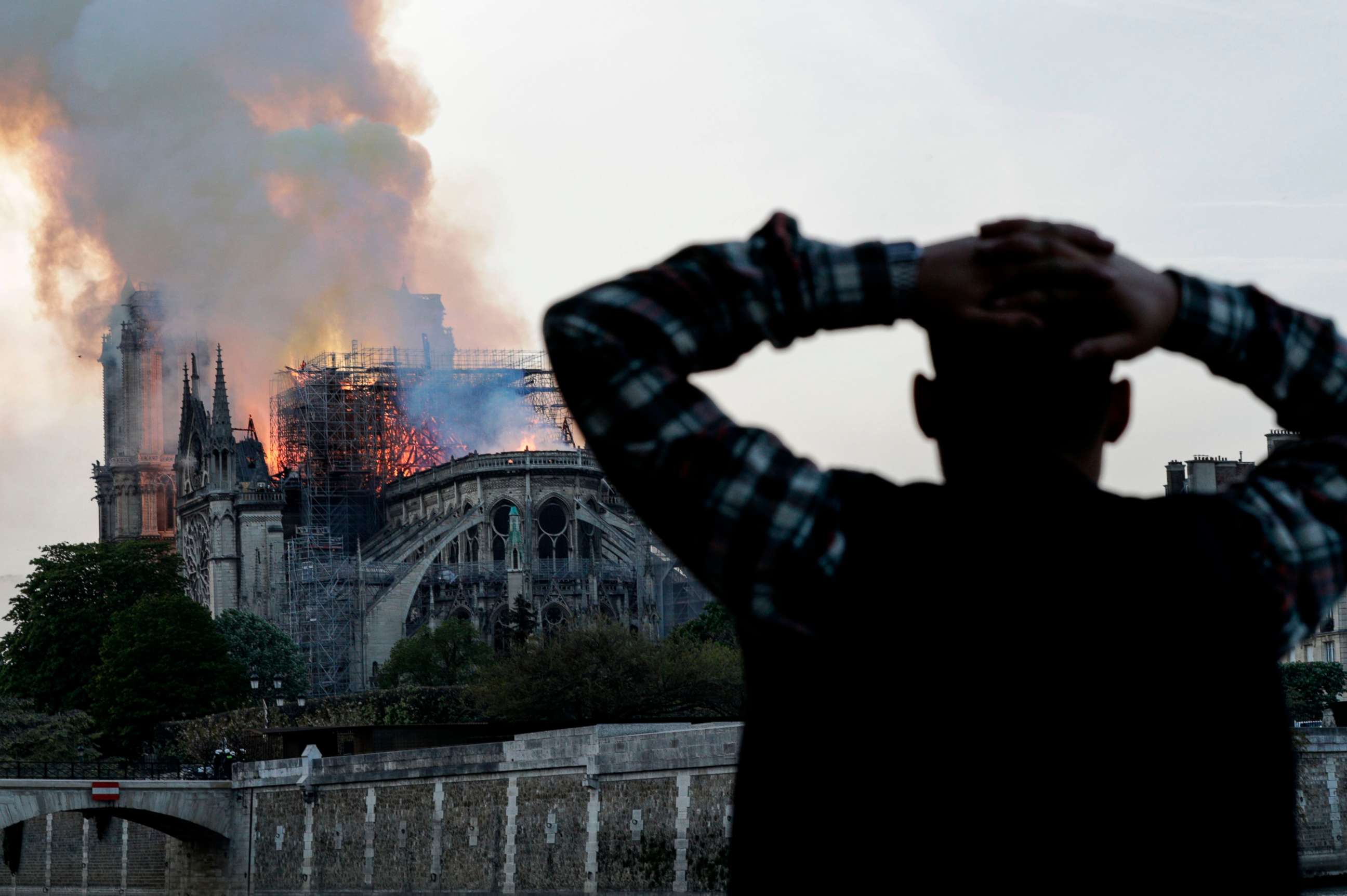 PHOTO: A man watches Notre-Dame Cathedral burn in Paris, April 15, 2019.