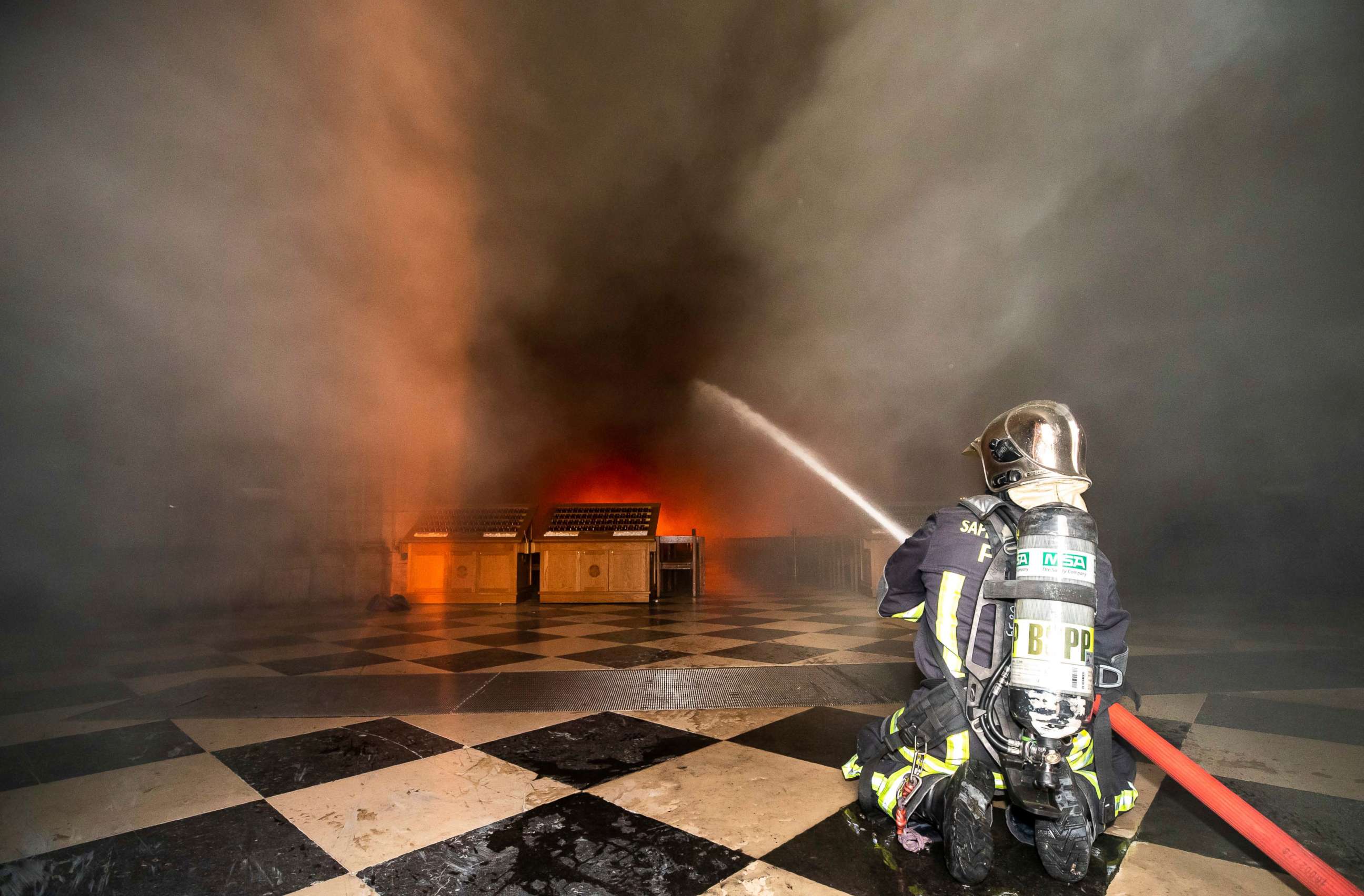 PHOTO: This photo provided Tuesday April 16, 2019 by the Paris Fire Brigade shows fire fighters spraying water inside Notre Dame cathedral, Monday April 15, 2019.