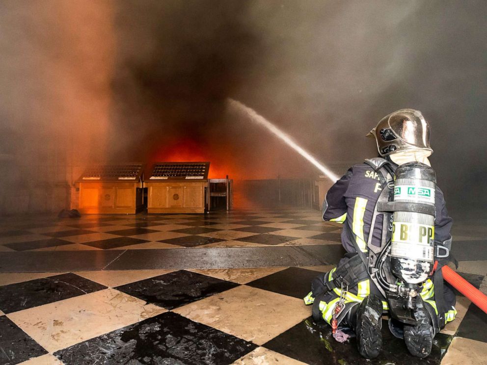 PHOTO: This photo provided Tuesday April 16, 2019 by the Paris Fire Brigade shows fire fighters spraying water inside Notre Dame cathedral, Monday April 15, 2019.