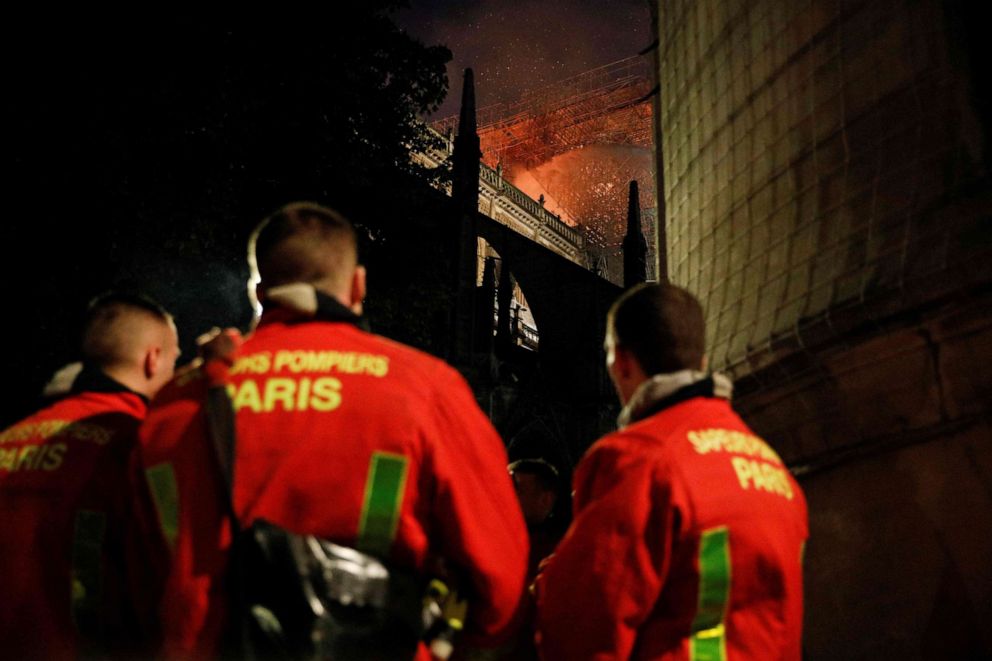 PHOTO: Firefighters watch the flames billowing from the roof at Notre Dame Cathedral in Paris on April 15, 2019.