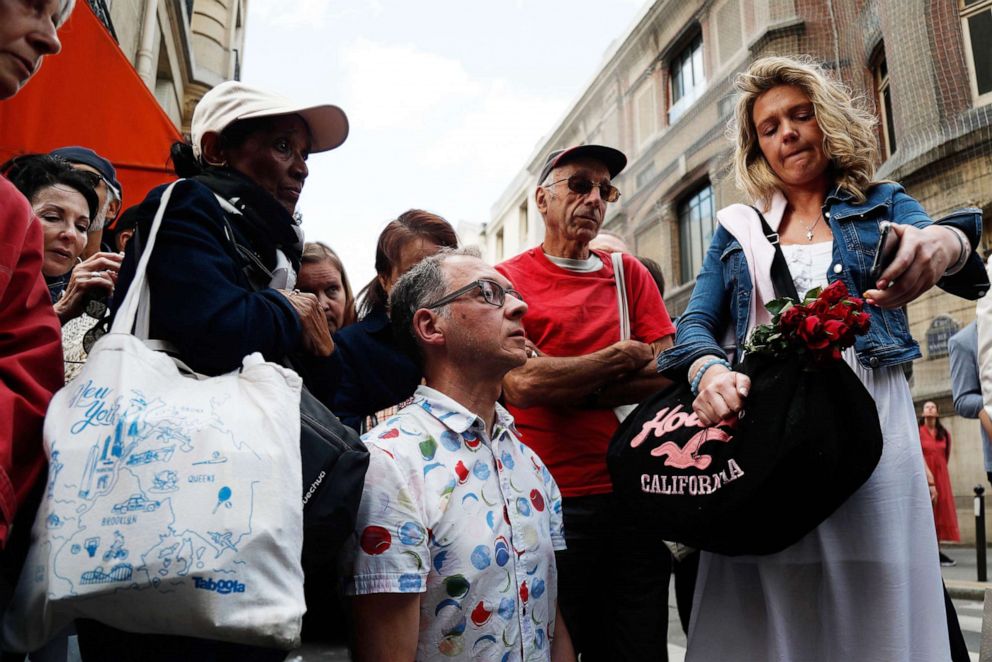 PHOTO: People react as they watch a live feed of the first mass inside a side chapel of the Notre-Dames de Paris Cathedral in Paris, June 15, 2019.