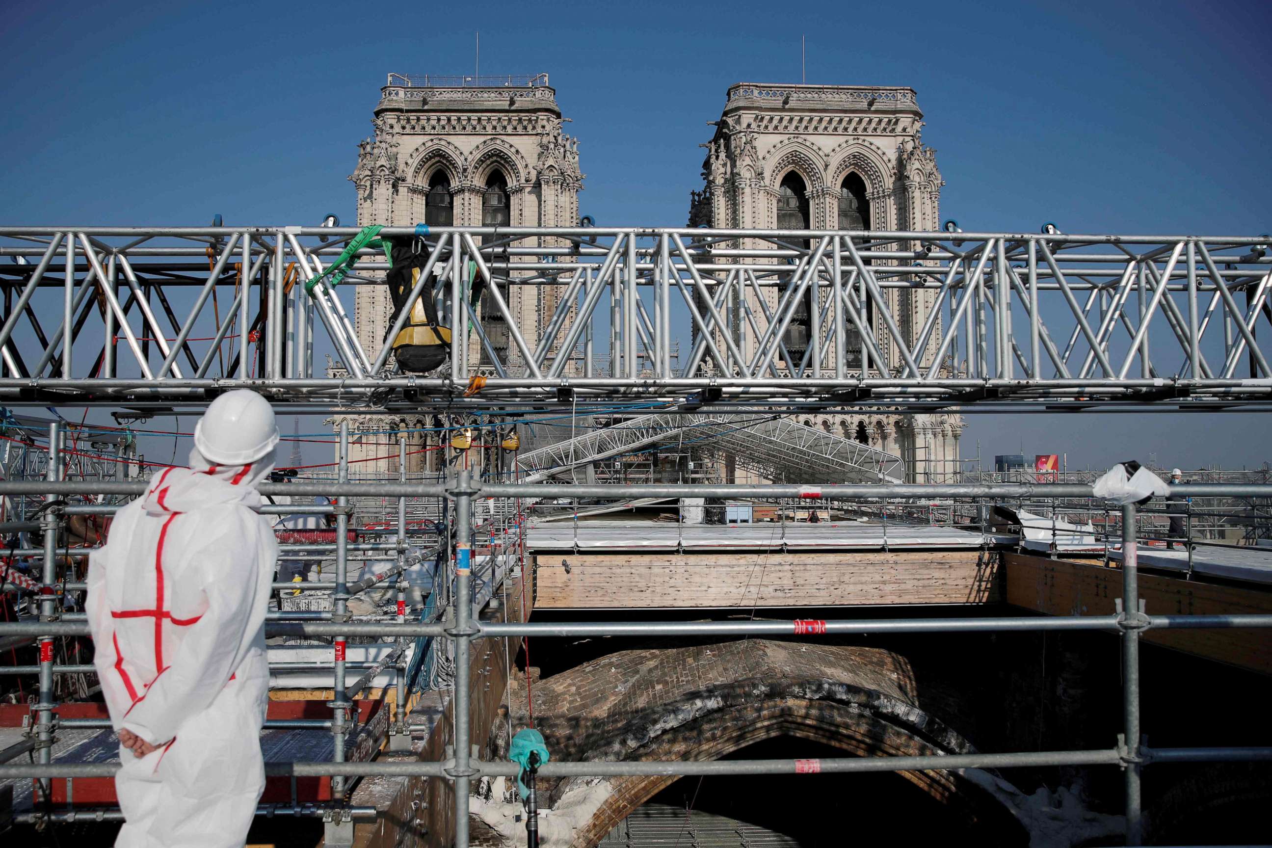 PHOTO: A person stands on the roof of the Notre-Dame de Paris Cathedral ahead of a visit of French President two years after the blaze that made the spire collapsed and destroyed much of the roof, in Paris on April 15, 2021.