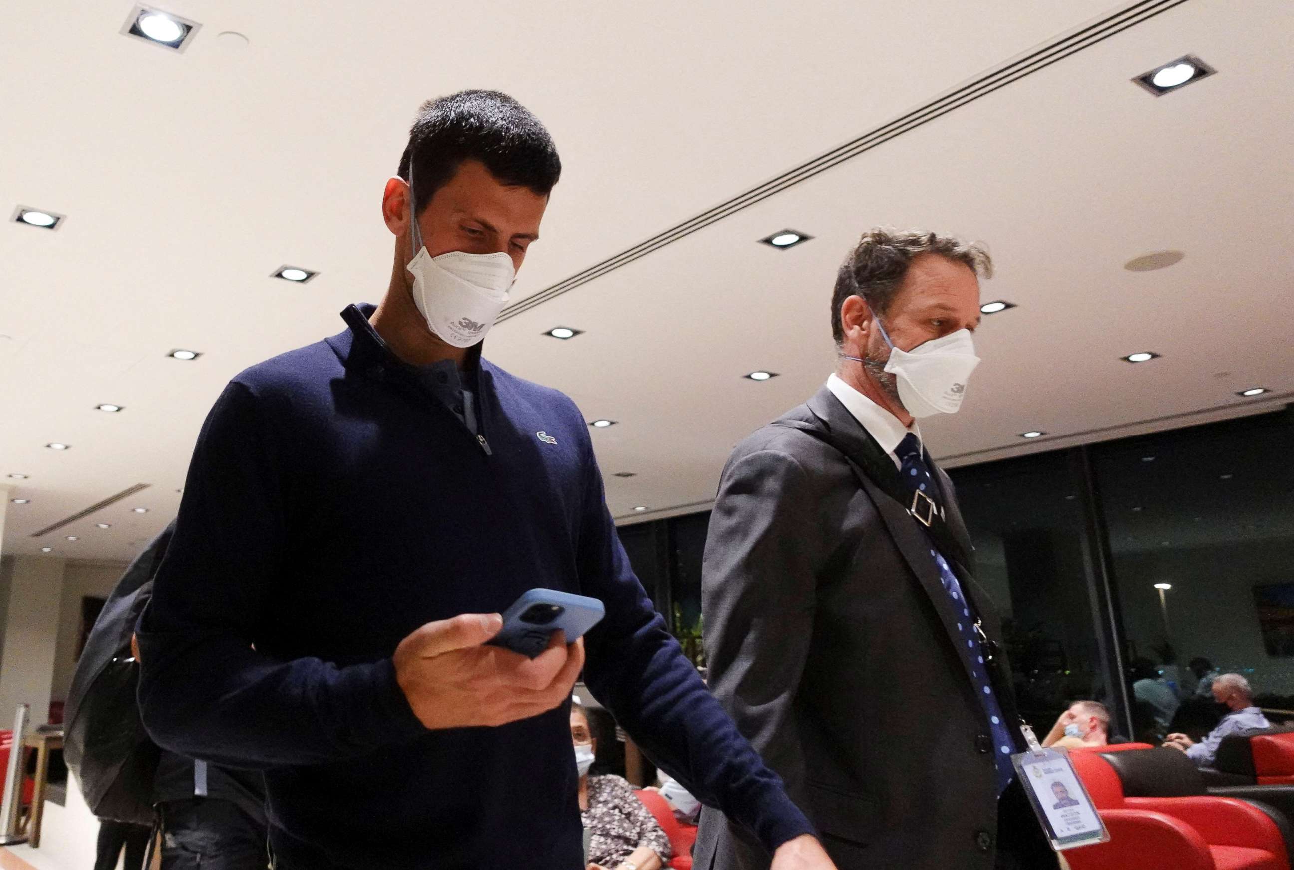 PHOTO: Serbian tennis player Novak Djokovic walks in Melbourne Airport before boarding a flight, after the Federal Court upheld a government decision to cancel his visa to play in the Australian Open, in Melbourne, Australia, Jan. 16, 2022.
