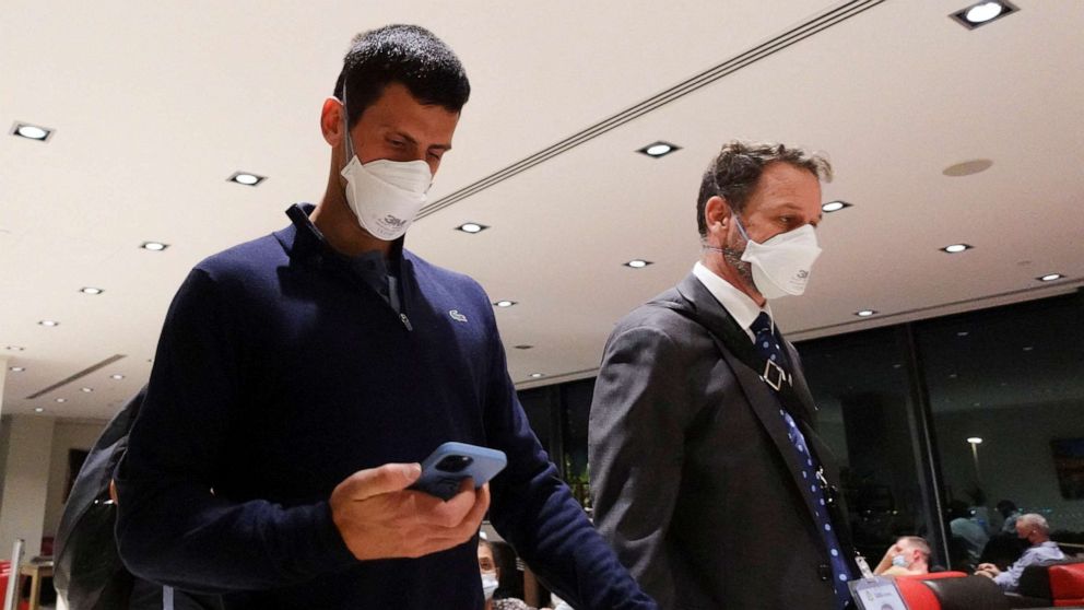 PHOTO: Serbian tennis player Novak Djokovic walks in Melbourne Airport before boarding a flight, after the Federal Court upheld a government decision to cancel his visa to play in the Australian Open, in Melbourne, Australia, Jan. 16, 2022.