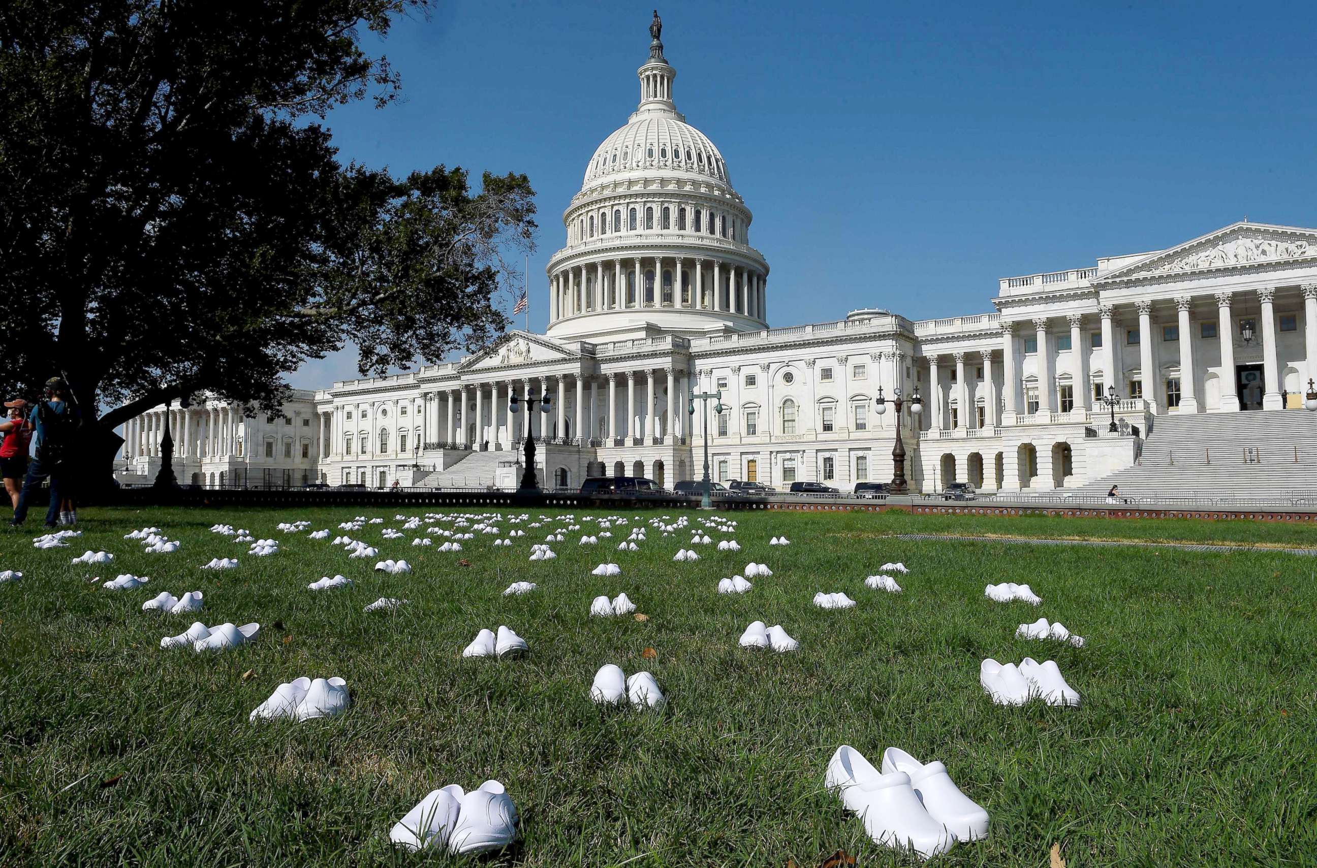 PHOTO: National Nurses United (NNU) display 164 white clogs shoes outside the US Capitol to honor the more than 160 nurses who have lost their lives from COVID-19 in the United States, in Washington, DC, July 21, 2020.