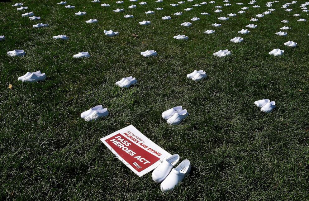 PHOTO: National Nurses United (NNU) display 164 white clogs shoes outside the US Capitol to honor the more than 160 nurses who have lost their lives from COVID-19 in the United States, in Washington, DC, July 21, 2020.