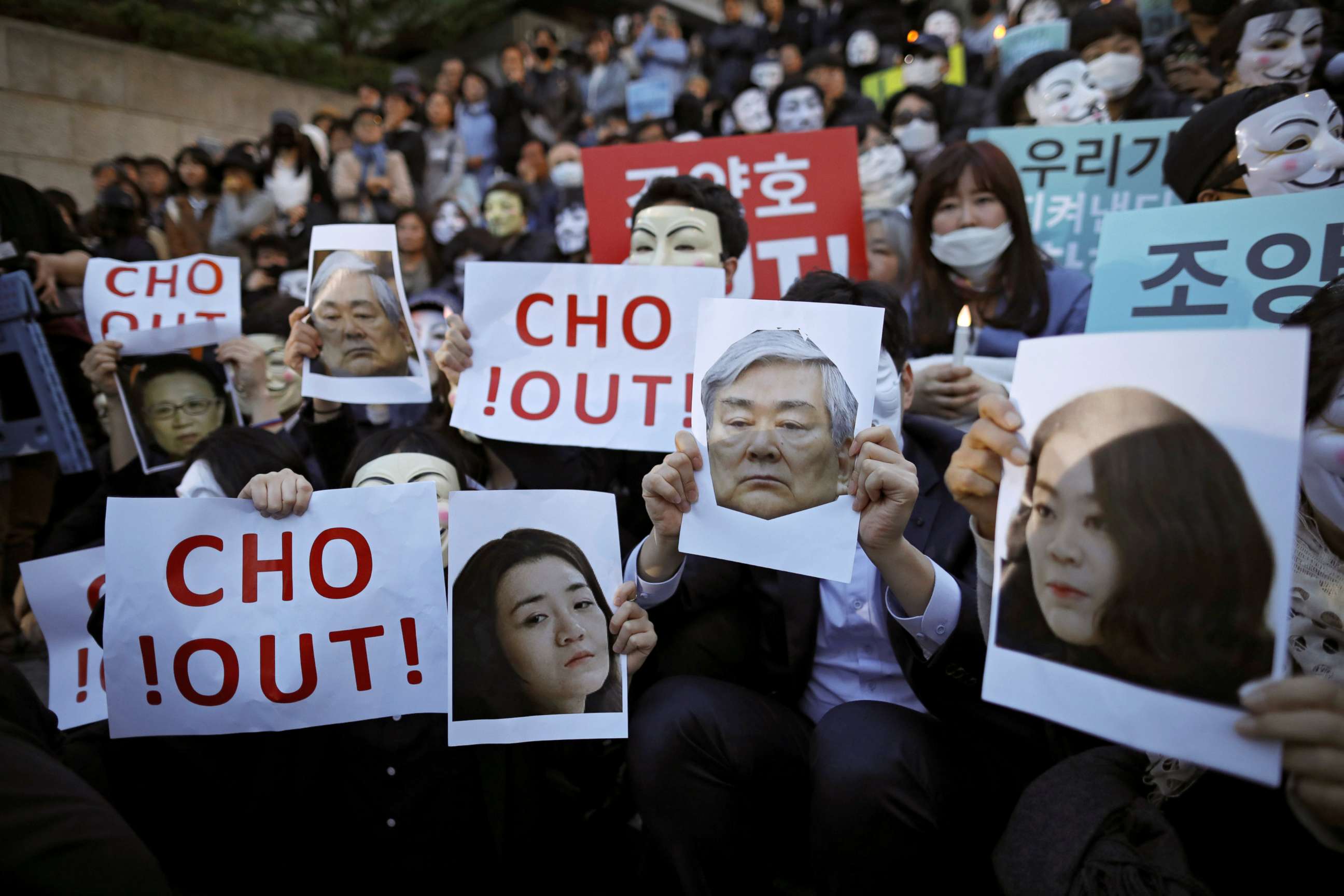 PHOTO: People hold portraits depicting Korean Air Lines' chairman Cho Yang-ho and his daughters Cho Hyun-ah and Cho Hyun-min as they take part in a protest against the abuse of power by them, in central Seoul, South Korea, May 4, 2018.