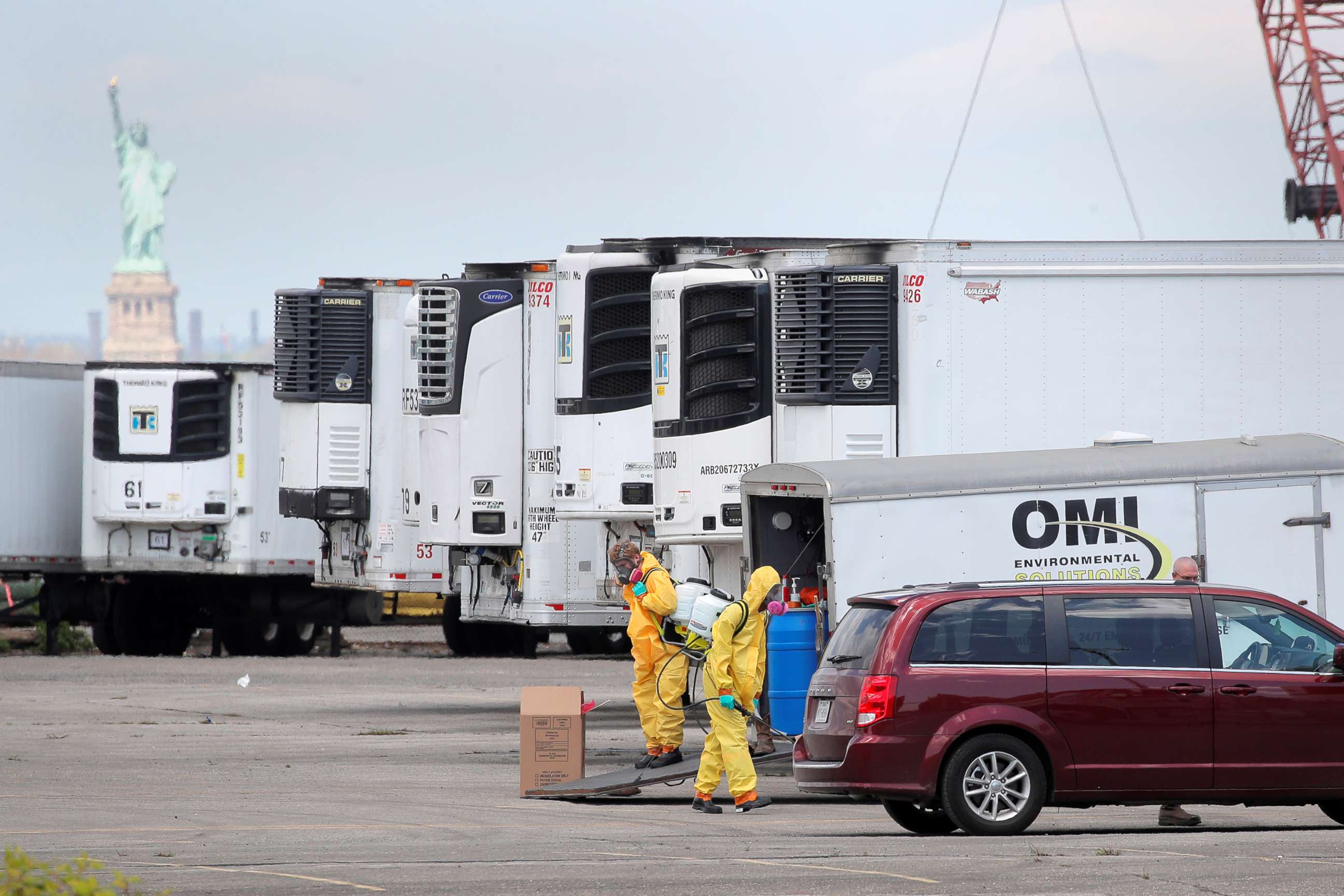 PHOTO: Workers are seen next to refrigerated tractor trailers used as a temporary morgue during the outbreak of the coronavirus disease (COVID-19) in the Brooklyn borough of New York City, May 4, 2020.
