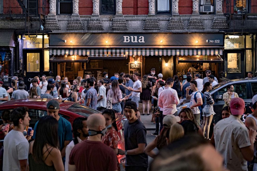 PHOTO: People drink outside a bar during the reopening phase following the coronavirus outbreak in the East Village neighborhood in New York City, June 12, 2020.