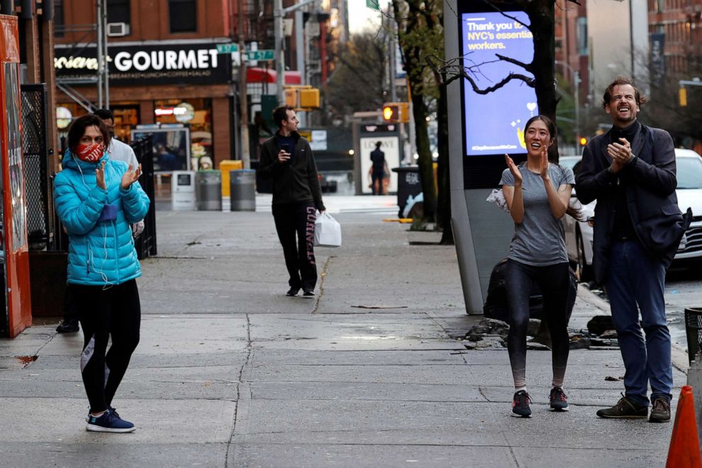 PHOTO: People stand and cheer for healthcare workers outside Mount Sinai West Hospital at 7pm on Manhattan's Upper West Side during the outbreak of the coronavirus disease (COVID-19) in New York City, April 13, 2020.