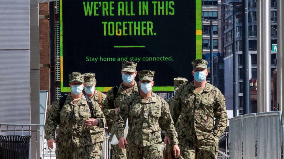 PHOTO: U.S. military personnel wearing face masks arrive at the Jacob K. Javits Convention Center which is being used as a field hospital during the outbreak of the coronavirus disease (COVID-19), in New York City, April 7, 2020.