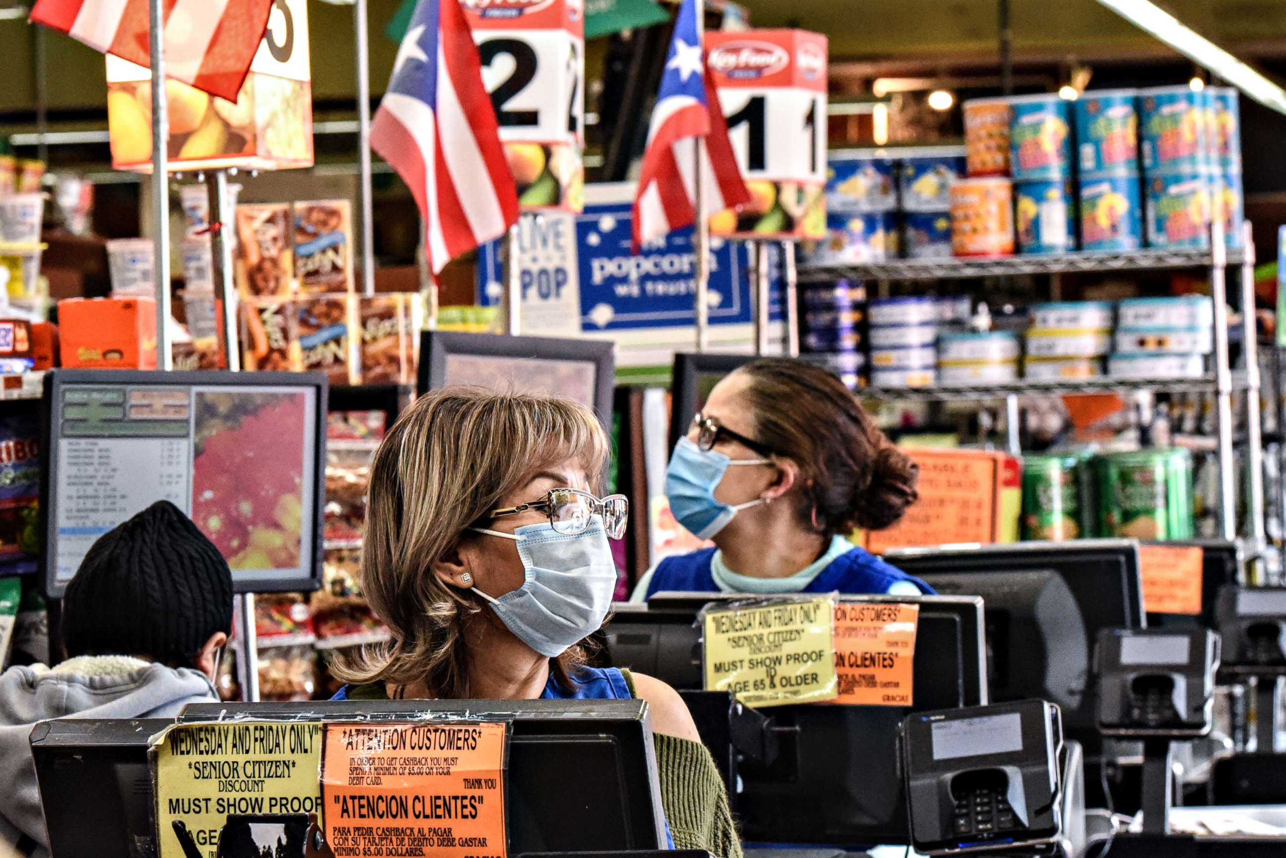 PHOTO: Cashiers work in a grocery store in the Bushwick neighborhood of Brooklyn during the COVID-19 pandemic,  on April 2, 2020, in New York City.