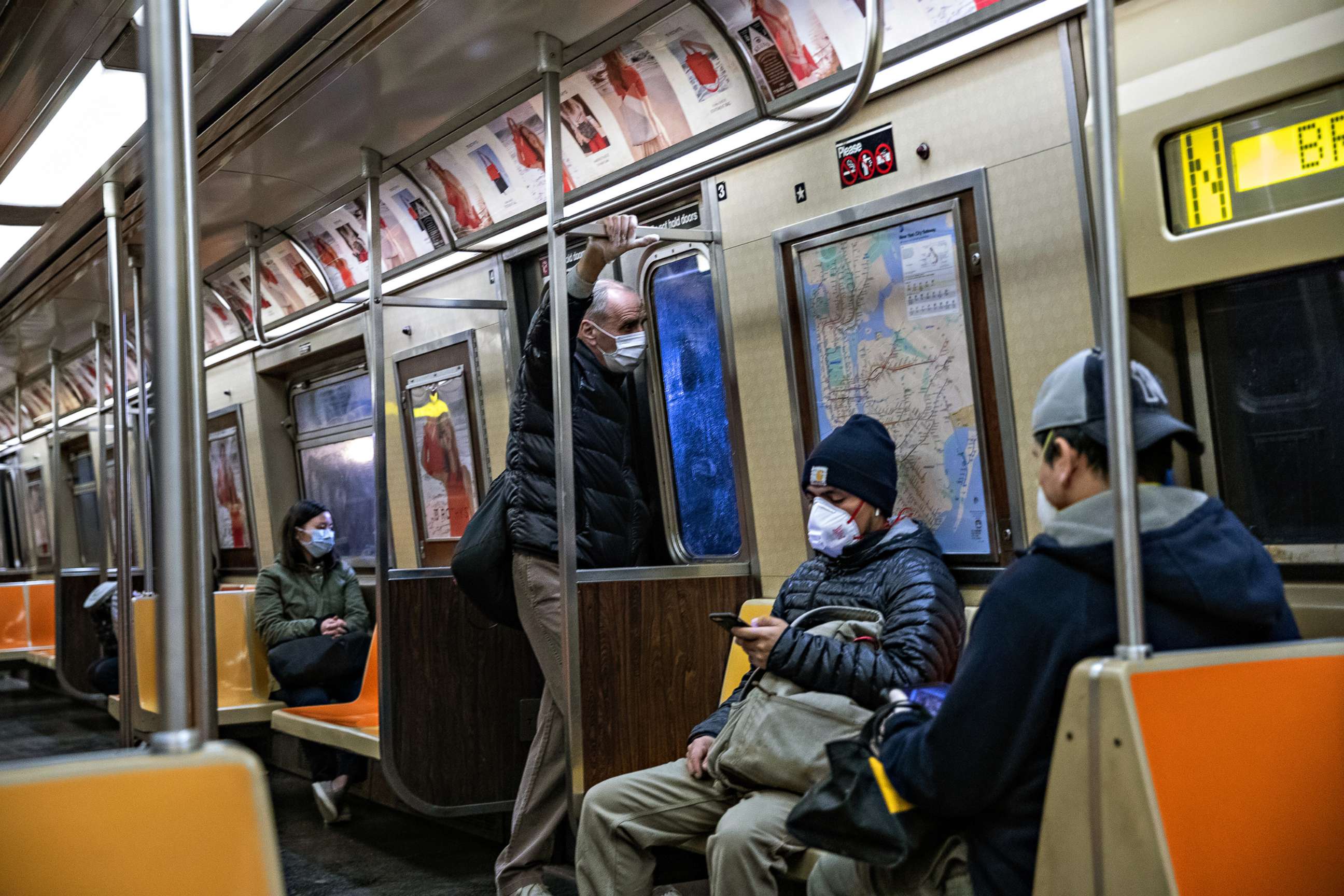 PHOTO: Passengers wearing face masks ride the subway, on April 28, 2020, in New York City.