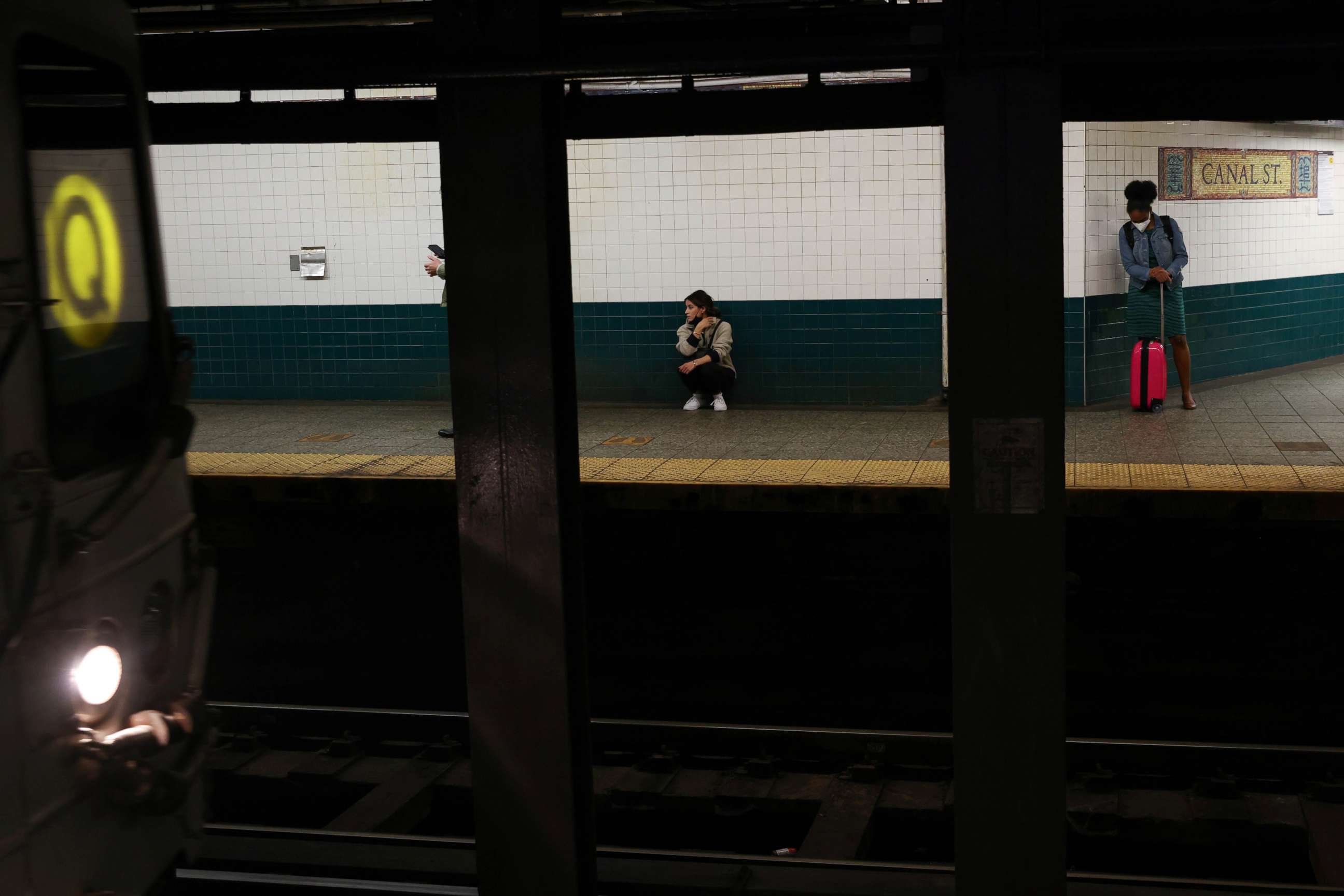PHOTO: Subway riders wait for a train at the Canal Street station in the Chinatown section of Manhattan in New York, Oct. 12, 2021.