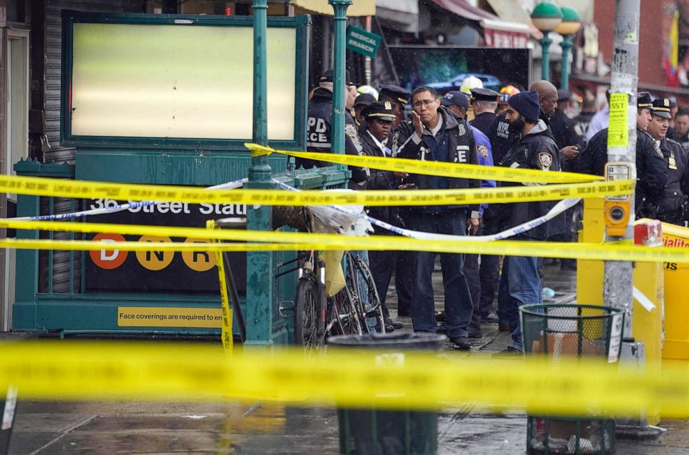 PHOTO: New York City Police Department personnel gather at the entrance to a subway stop after a shooting in the Brooklyn borough of New York, April 12, 2022.
