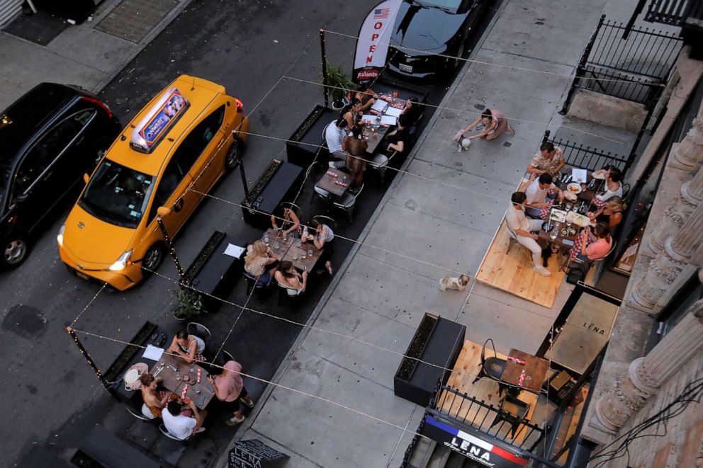 PHOTO: People eat outside of LENA Winebar as restaurants are permitted to offer al fresco dining as part of phase 2 reopening during the COVID-19 outbreak in the Lower East Side of Manhattan in New York City, June 27, 2020.