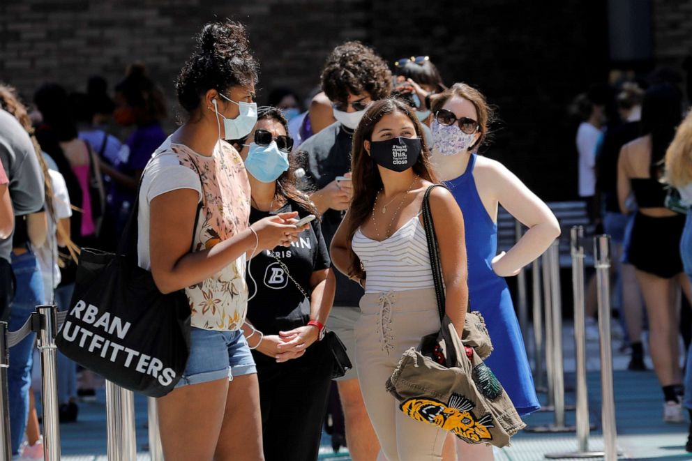 PHOTO: Students wear protective masks as they wait in line at a COVID-19 testing site set for returning students, faculty and staff on the main New York University (NYU) campus in New York City, Aug. 18, 2020.