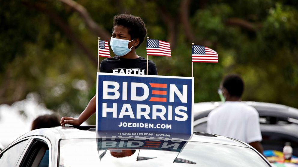 PHOTO: A supporter waits at a drive-in rally for former President Barack Obama to campaign on behalf of Democratic presidential nominee and his former Vice President Joe Biden in Miami, Oct. 24, 2020.