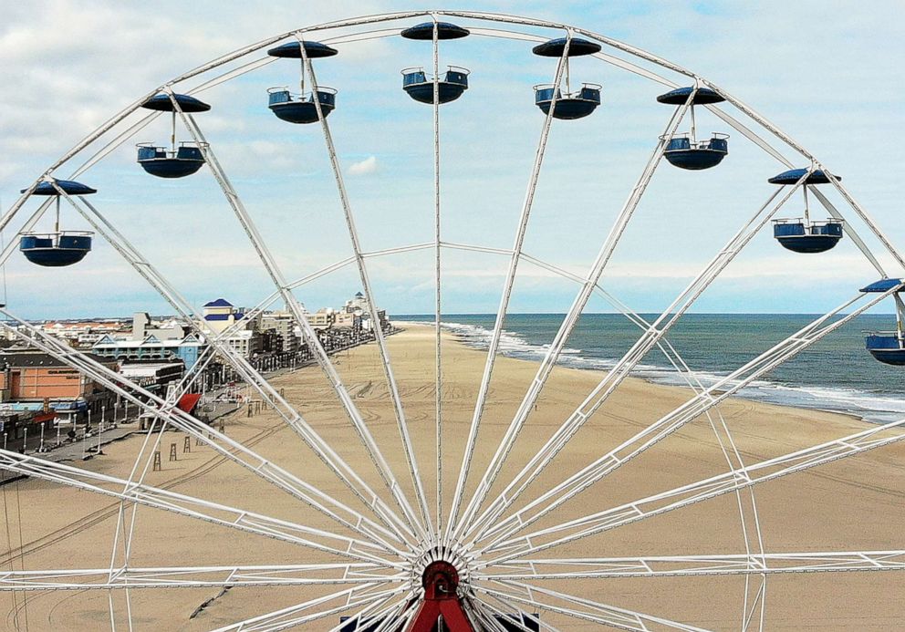 PHOTO: The empty beach stretches out through the spokes of a ferris wheel, April 27, 2020, in Ocean City, Maryland, while closed during the coronavirus pandemic.