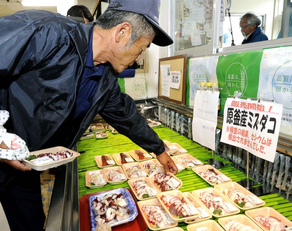 PHOTO: A man picks up a pack of octopus at a supermarket in Soma, Fukushima Prefecture, on June 25, 2012. 