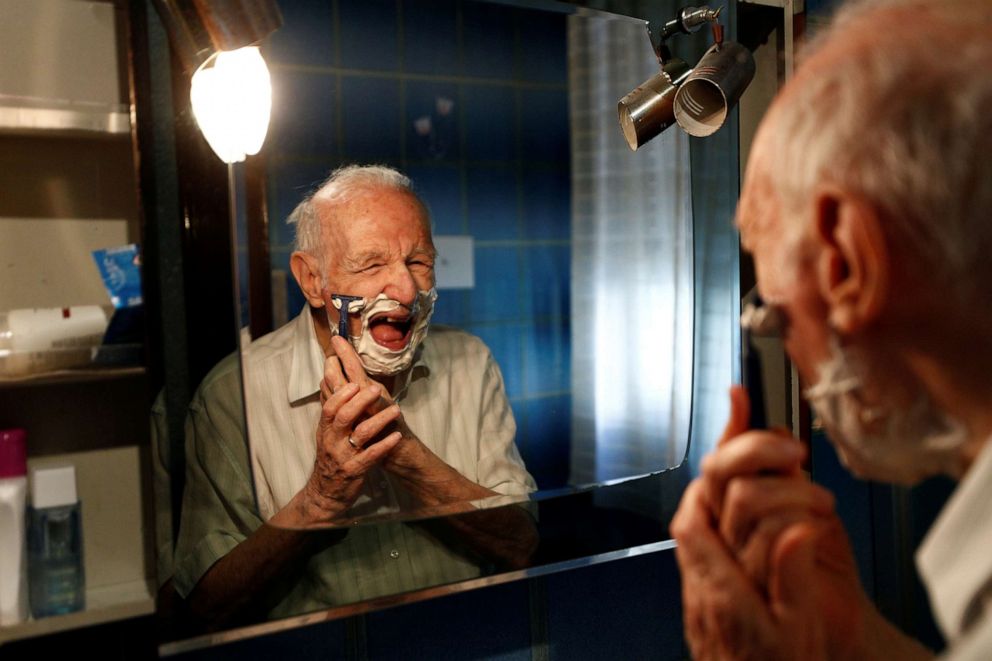 PHOTO: Giuseppe Paterno, 96, Italy's oldest student, shaves his beard as he gets ready for the day, two days before he graduates from The University of Palermo with an undergraduate degree in history and philosophy in Palermo, Italy, July 27, 2020. 