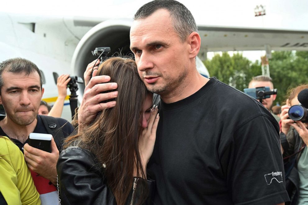PHOTO: Ukrainian film director Oleg Sentsov hugs his daughter Alina Sentsova after he disembarked from a plane on September 7, 2019.