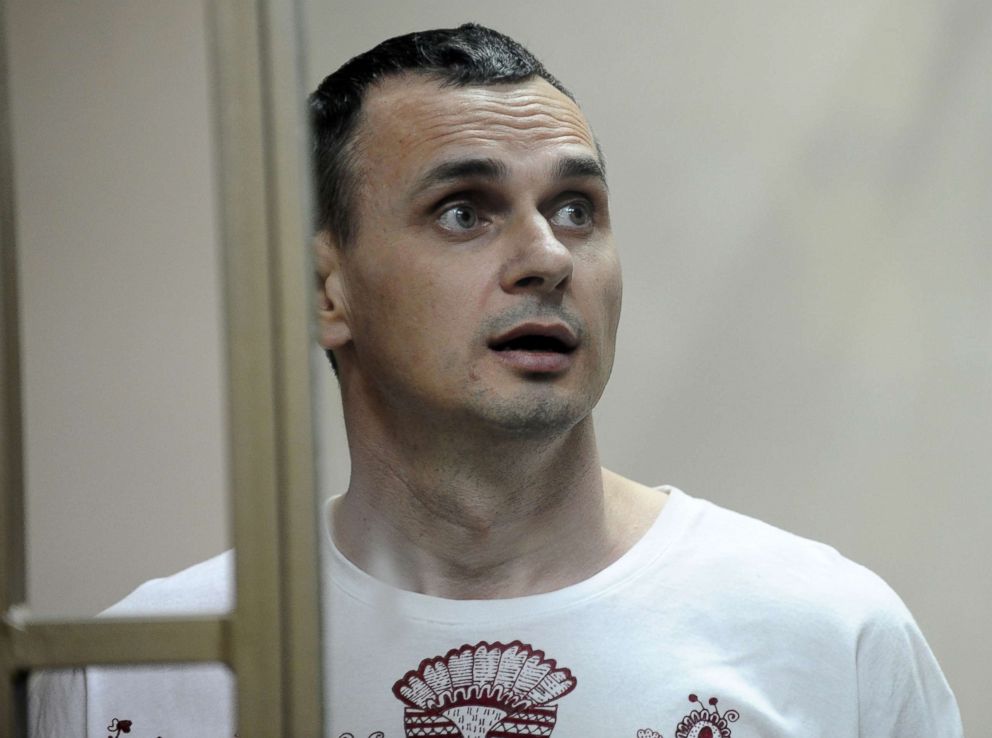 PHOTO: Oleg Sentsov reacts as the verdict is delivered as he stands behind bars at a court in Rostov-on-Don, Russia, Aug. 25, 2015.