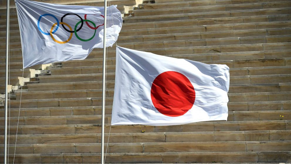PHOTO: Japan's flag is raised next to the Olympic flag during the olympic flame handover ceremony for the 2020 Tokyo Summer Olympics, March 19, 2020, in Athens. 
