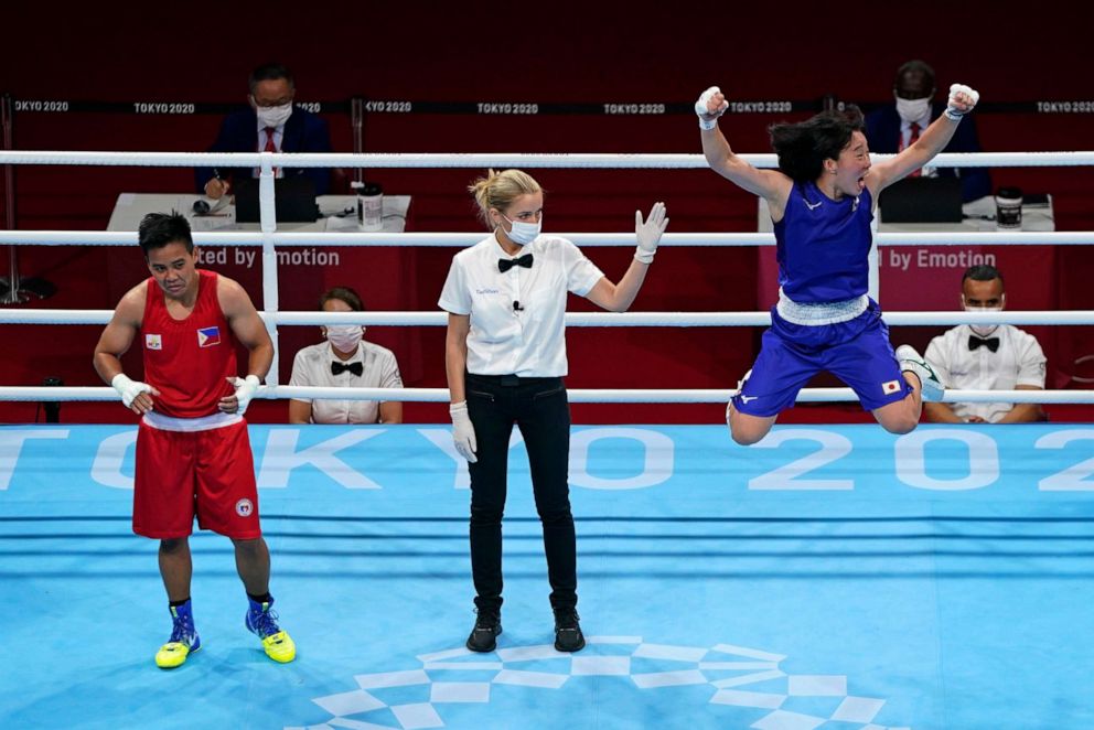 PHOTO: Japan's Sena Irie, right, celebrates defeating Philippines's Nesthy Petecio, left, to win the women's featherweight 60-kg final boxing match at the 2020 Summer Olympics, Aug. 3, 2021, in Tokyo, Japan.