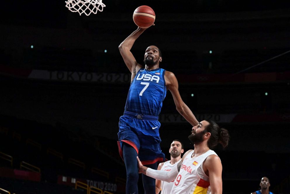 PHOTO: Kevin Durant goes for a dunk past Spain's Ricard Rubio in the men's quarter-final basketball match during the Tokyo 2020 Olympic Games at the Saitama Super Arena in Saitama on Aug. 3, 2021.
