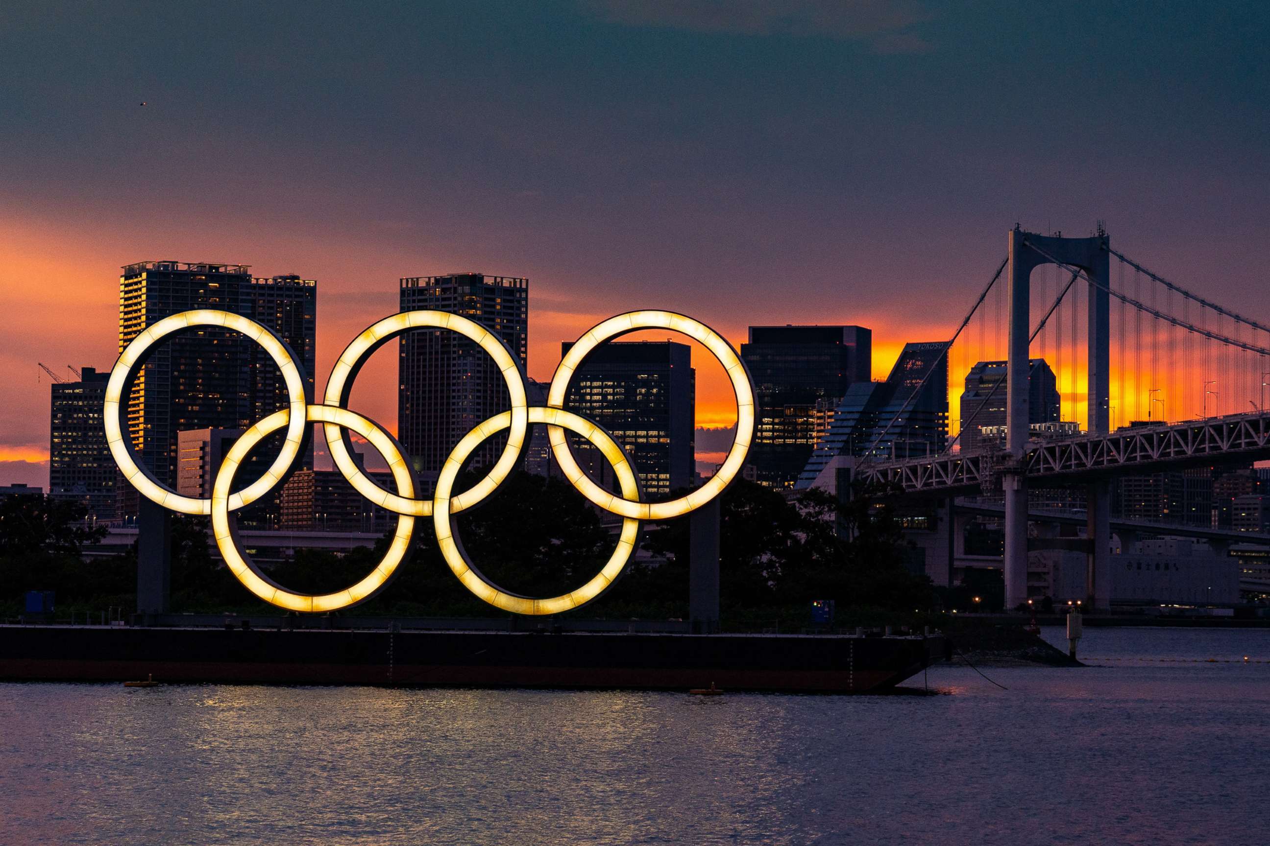 PHOTO: The Olympic rings floating on a barge in Tokyo Bay in front of the Rainbow Bridge, in Tokyo, July 20, 2021.