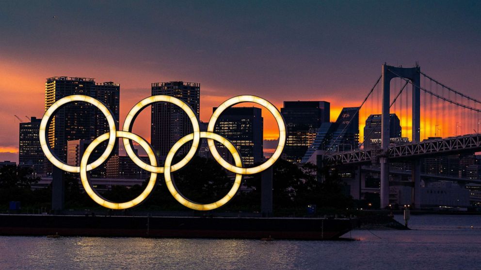 PHOTO: The Olympic rings floating on a barge in Tokyo Bay in front of the Rainbow Bridge, in Tokyo, July 20, 2021.