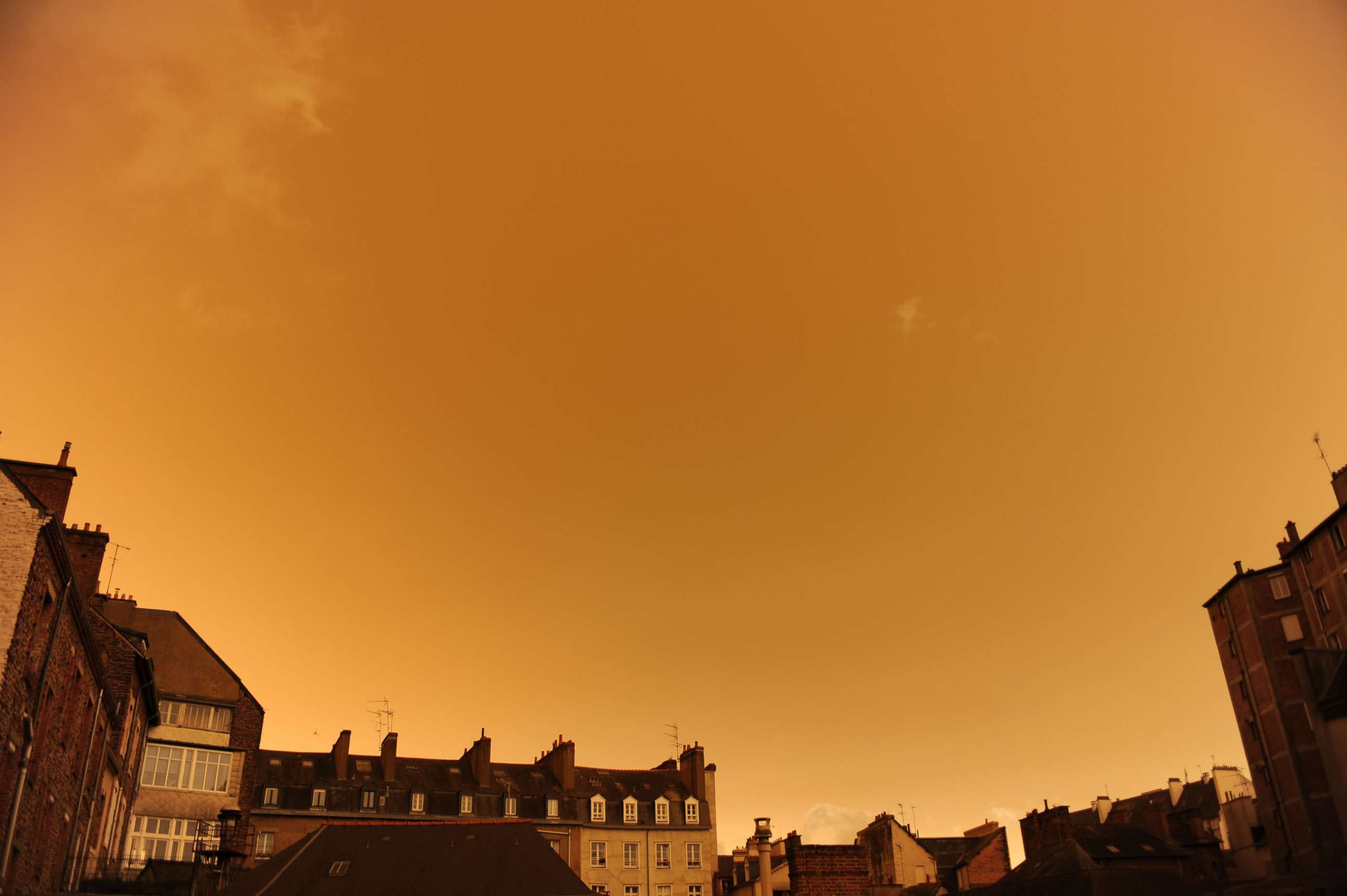 PHOTO: A surreal sky over central Rennes, western France, Oct. 16. 2017, after it turned a yellow-ochre color due to sand from the Sahara desert and dust from wildfires in Portugal being carried by wind.
