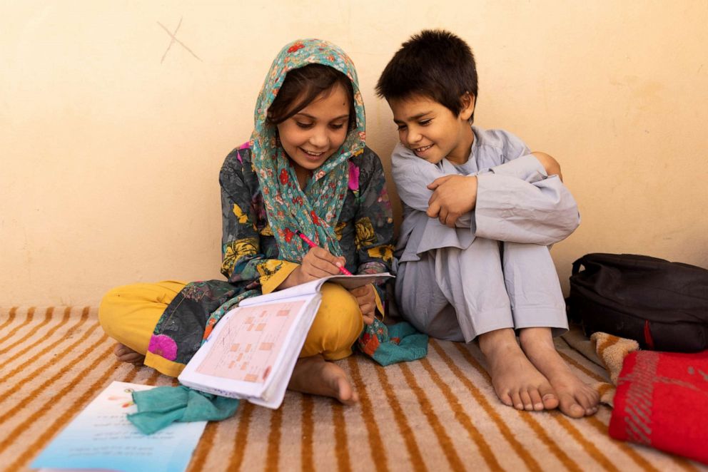 PHOTO: Samira, 9, and Aminullah help each other with homework at the orphanage in Kabul, Afghanistan, Oct. 10, 2021.  