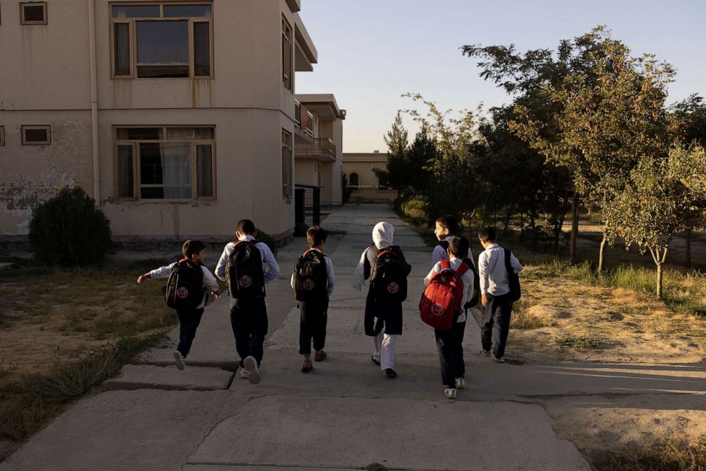 PHOTO: Samira, 9, and other children from the orphanage walk to the school bus in Kabul, Afghanistan, Oct. 12, 2021.