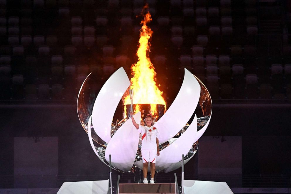 PHOTO: Japanese tennis player Naomi Osaka lights the Olympic Cauldron with the Olympic flame during the opening ceremony of the Tokyo 2020 Olympic Games, at the Olympic Stadium, in Tokyo, on July 23, 2021.