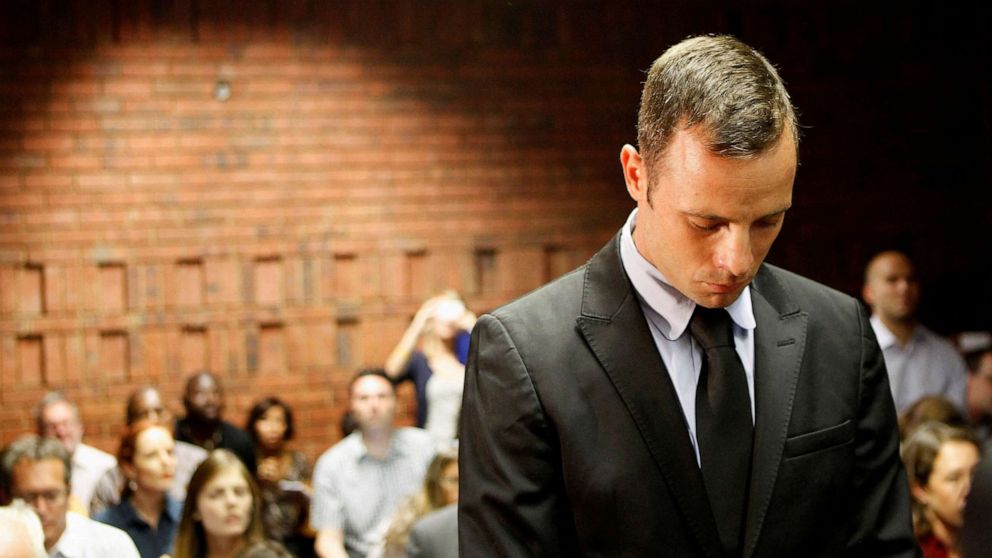 PHOTO: In this Feb 20, 2013 file photo Oscar Pistorius stands in the dock during a break in court proceedings at the Pretoria Magistrates court.