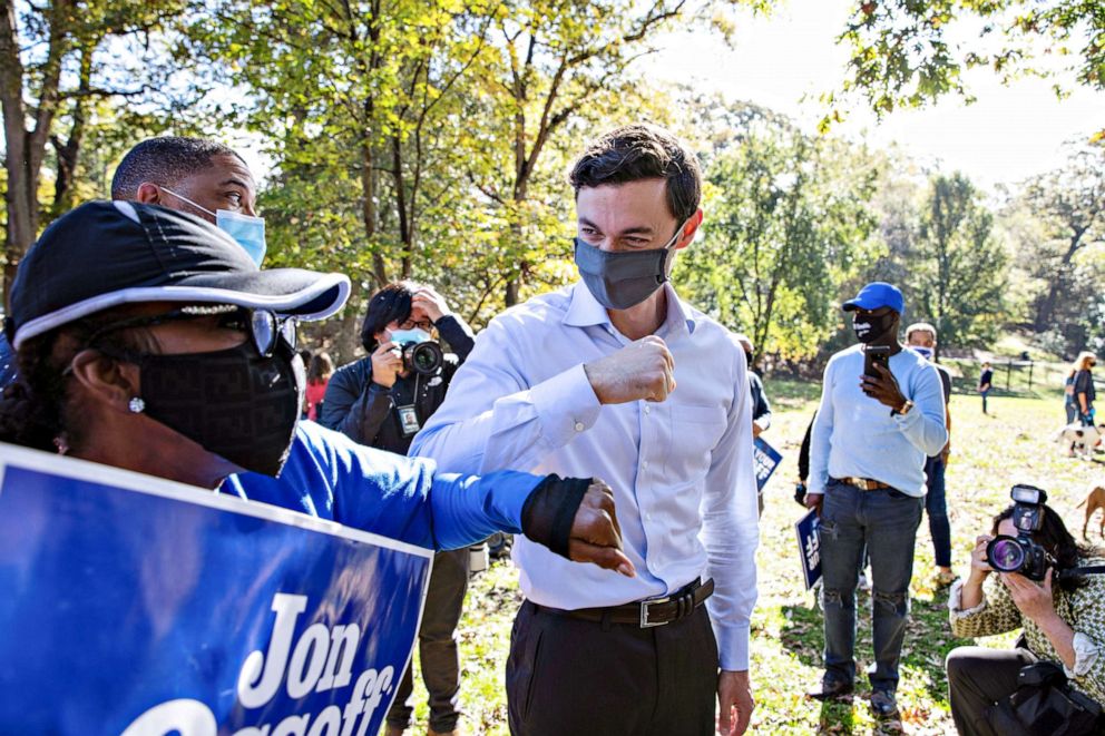 PHOTO: A supporter elbow bumps with Democratic U.S. Senate candidate Jon Ossoff after he spoke at a news conference in Grant Park after the election in Atlanta, Nov. 6, 2020.