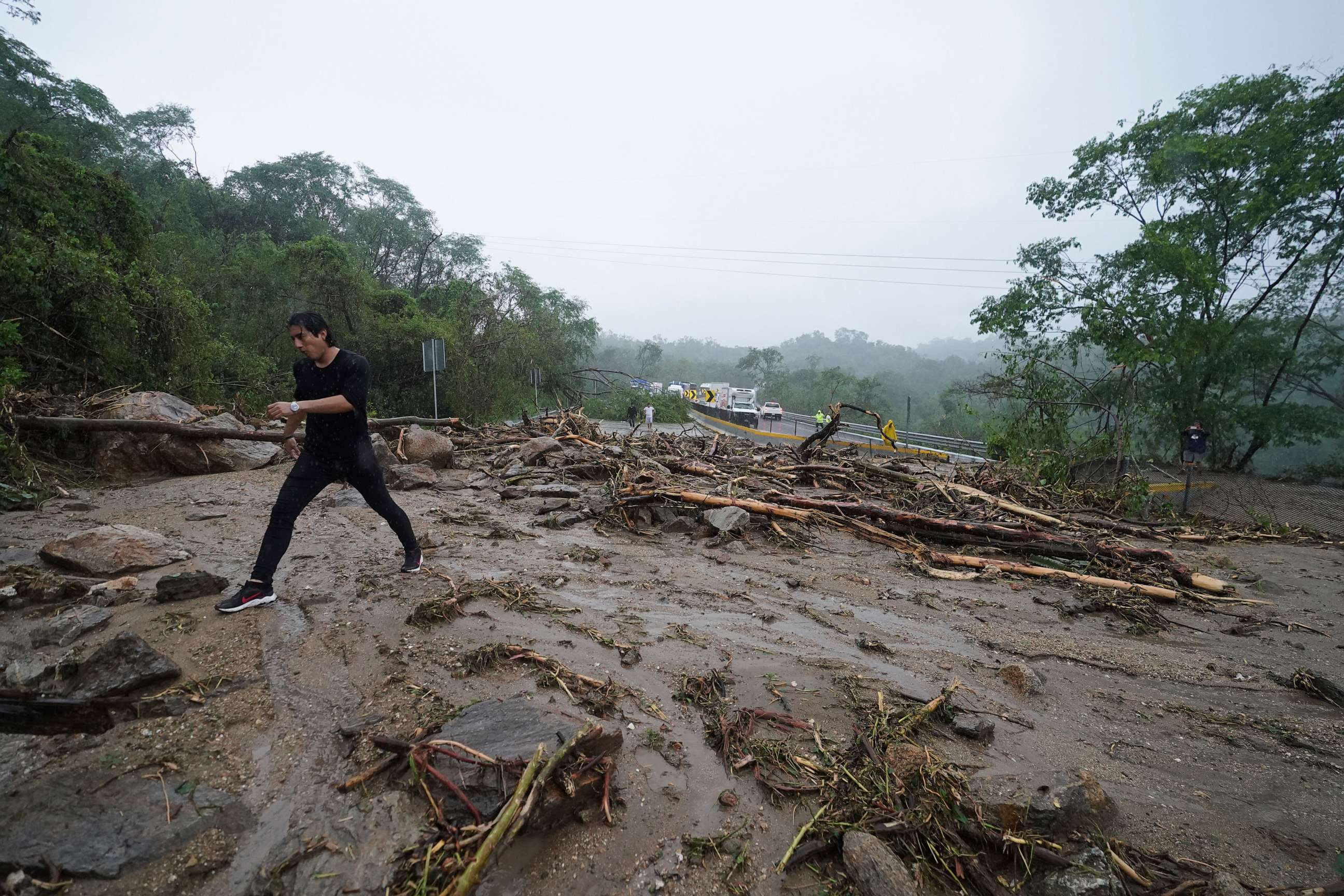 PHOTO: A man crosses a highway blocked by a landslide triggered by Hurricane Otis near Acapulco, Mexico, Wednesday, Oct. 25, 2023.